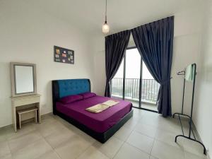 a bedroom with a purple bed and a window at Sandakan Homestay Sea-Forest View Apartment 2R2B 海森雙景公寓 in Sandakan