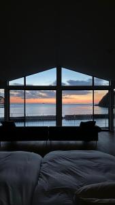 a bedroom with a bed and a view of the ocean at 小豆島の貸切宿　おぼろととろろ　【最大10名様】【一日一組限定】【瀬戸内オーシャンフロントのお宿】 in Shodoshima