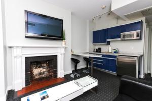 a kitchen with a fireplace with a tv above it at Furnished Newbury Street Studio, #6 in Boston