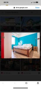una imagen de un dormitorio con una cama con paredes azules en The Peacock Oasis en Ozamis