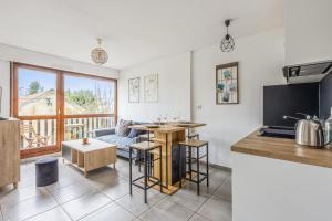 a kitchen and living room with a couch and a table at Nice apartment with balcony in Cabourg - Welkeys in Cabourg