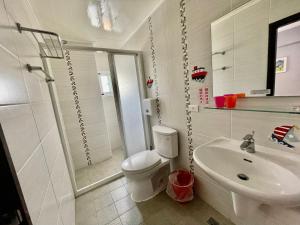 biała łazienka z toaletą i umywalką w obiekcie SummerMallika 夏茉民宿 w mieście Magong