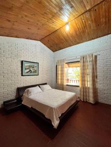 Ginebra的住宿－Casa de la sierra，一间卧室设有一张大床和窗户
