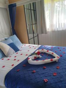 a bed with red rose petals on it at Holly Lodge 12 Hot Tub in York