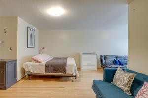 1 dormitorio con 1 cama y 1 sofá azul en Cozy Oakland Studio Rental, 13 Mi to San Francisco en Oakland