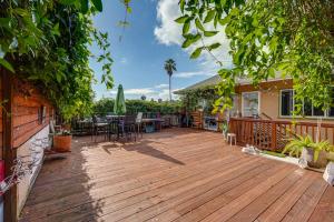 a wooden deck with a table and chairs on a house at Cozy Oakland Studio Rental, 13 Mi to San Francisco in Oakland