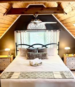 a bedroom with a large bed with a window at Heaven on Lake Sinclair in Resseaus Crossroads