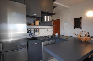 a kitchen with a stainless steel refrigerator and a sink at Apartments with parking space Porat, Krk - 22268 in Porat