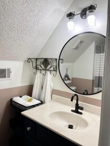 a bathroom with a sink and a mirror at Heaven on Lake Sinclair in Resseaus Crossroads