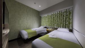 Postel nebo postele na pokoji v ubytování Hotel Villa Fontaine Tokyo-Jimbocho