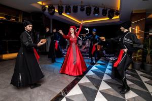 a group of people dancing on a dance floor at Queen apartments in batumi in Batumi