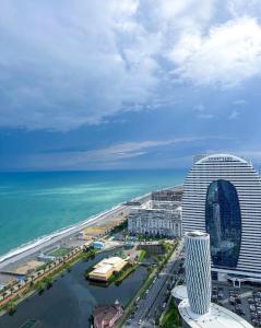 an aerial view of a building next to the ocean at Queen apartments in batumi in Batumi