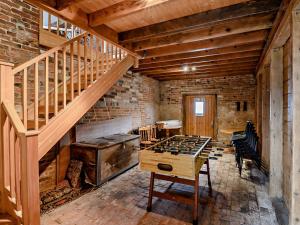 a room with a wooden staircase and a wooden table at 1 Bed in Mattersey 93151 in Mattersey