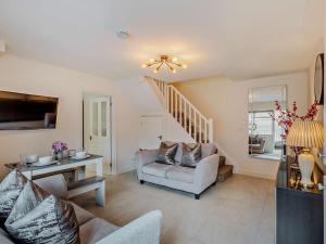 a living room with a couch and a stair case at 2 Bed in Warwick 93085 in Warwick