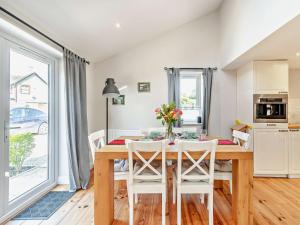 a kitchen and dining room with a wooden table and chairs at 2 Bed in Bridlington 13mls E 93140 in Butterwick