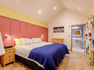 a bedroom with a large bed and a red headboard at 1 Bed in Lockerbie 93110 in Lockerbie