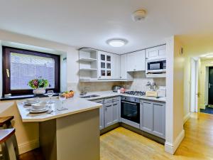 a kitchen with white cabinets and a counter top at 1 Bed in Bowness-On-Windermere 93087 in Bowness-on-Windermere