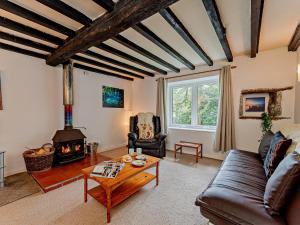 a living room with a couch and a wood stove at 2 Bed in Machynlleth 93079 in Cemmaes