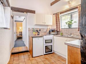 a kitchen with white appliances and a window at 2 Bed in Minehead 90925 in Minehead