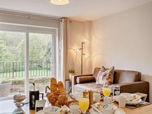 a living room with a couch and a table with food at 2 Bed in Knaresborough 91968 in Knaresborough