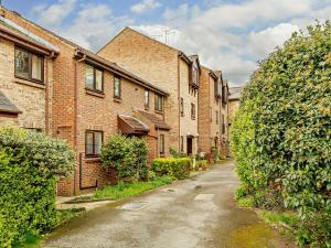 an empty street with brick buildings and bushes at 2 Bed in Knaresborough 91968 in Knaresborough