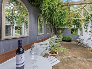a bottle of wine sitting on a table in a greenhouse at 2 Bed in Barnstaple 5mls N 93022 in Chapelton