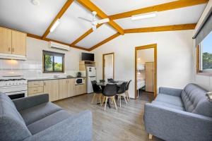 a kitchen and living room with couches and a table at Eureka Stockade Holiday Park in Ballarat +25 photos