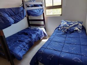 a bedroom with two bunk beds and a ladder at Departamento Ciudad de Caldera, Bahia Inglesa in Caldera