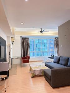 a living room with a couch and a large window at Park View KLCC ,by DeLive Home in Kuala Lumpur