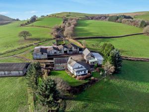 an aerial view of a large house in a field at 5 Bed in Brecon 90660 in Lower Chapel