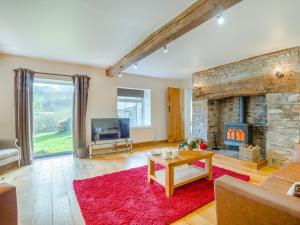 a living room with a fireplace and a tv at 5 Bed in Brecon 90660 in Lower Chapel