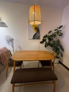 a dining room table with two chairs and a potted plant at 2BEDROOM Condo for rent in Quezon City in Manila