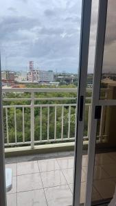 an open door to a balcony with a view of a city at 2BEDROOM Condo for rent in Quezon City in Manila