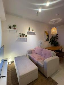 a living room with a couch and a table at 2BEDROOM Condo for rent in Quezon City in Manila