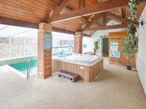 a large room with a hot tub and a pool at 2 Bed in Pickering 88957 in Newton