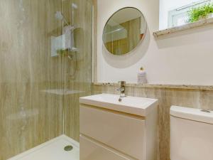 a bathroom with a toilet and a sink and a mirror at 1 Bed in Marazion 88008 in Ludgvan +10 photos