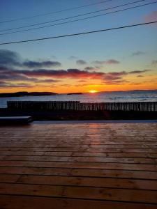 a sunset over the ocean with the sun setting at 2 Bedroom 2 Bathroom Oceanfront Oasis in Bonavista