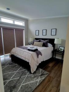 a bedroom with a large bed and a window at 2 Bedroom 2 Bathroom Oceanfront Oasis in Bonavista