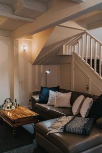 a living room with a couch and a staircase at Wild Orchid Olinda Private Luxury Cottage in Olinda