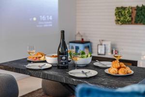 a table with a bottle of wine and plates of food at エクセルシア in Osaka +62 photos