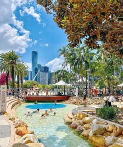 a group of people in a swimming pool at a resort at South bank Serviced Apartments in Brisbane