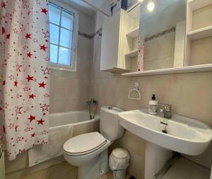 a bathroom with a toilet and a sink and a shower curtain at Lovely house in Bellaterra (10 min to UAB) in Cerdanyola del Valles