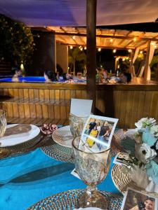 a table with plates and a wine glass on it at Bangalôs Flecheiras de Canaã in Flecheiras