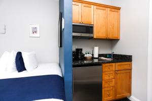 a small room with a bed and a kitchen at Heart of South End, Convenient, Comfy Studio #42 in Boston