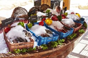 a bunch of vegetables in baskets on a table at Kempinski Hotel Soma Bay in Hurghada