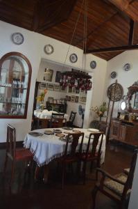 a dining room with a table and chairs and a mirror at Kandy Inn Madugalle’s family guest house in Kandy