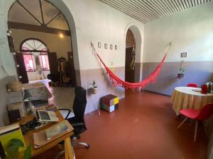 a room with a hammock in the middle of a room at Yorukàsa in São Luís