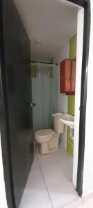 a bathroom with a toilet and a sink at Casa Blanca in Ibagué
