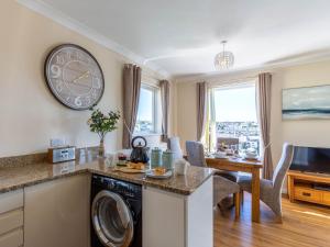 ブリクサムにある2 bed in Brixham 78185のキッチン、ダイニングルーム(壁掛け時計付)