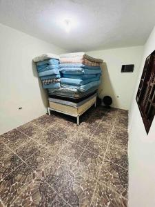 a room with a pile of clothes sitting on top of a floor at @ Chácara 5 Anjos - Jacuzzi Incrível Água Quente in Itanhaém